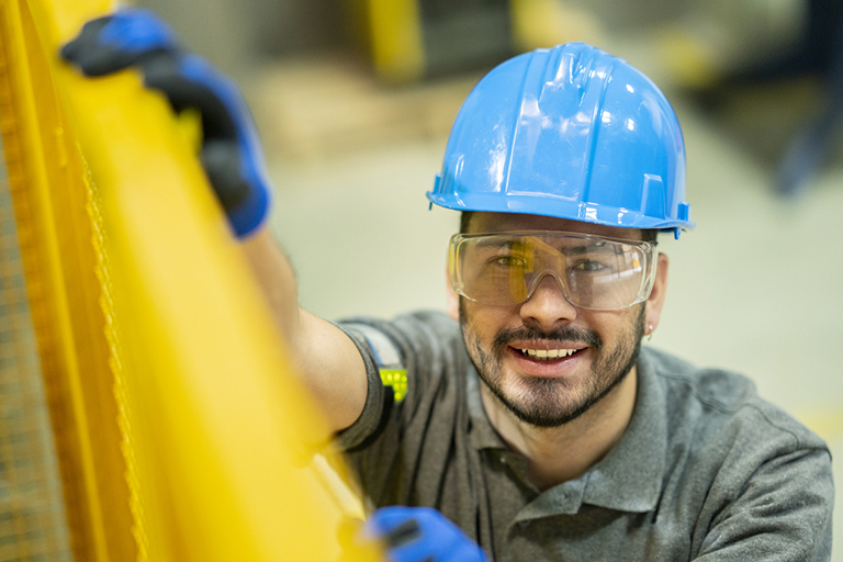 Workforce, Man opening a metal door in the warehouse