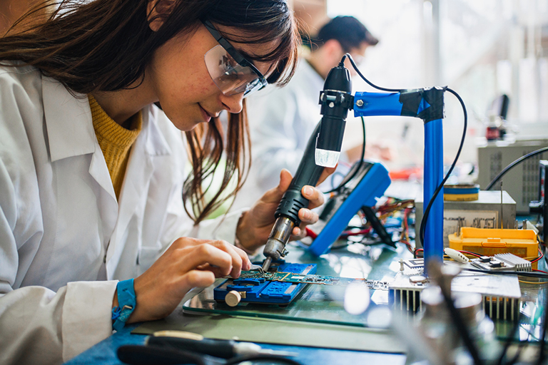 Workforce, Female electrician at work on an electrical panel