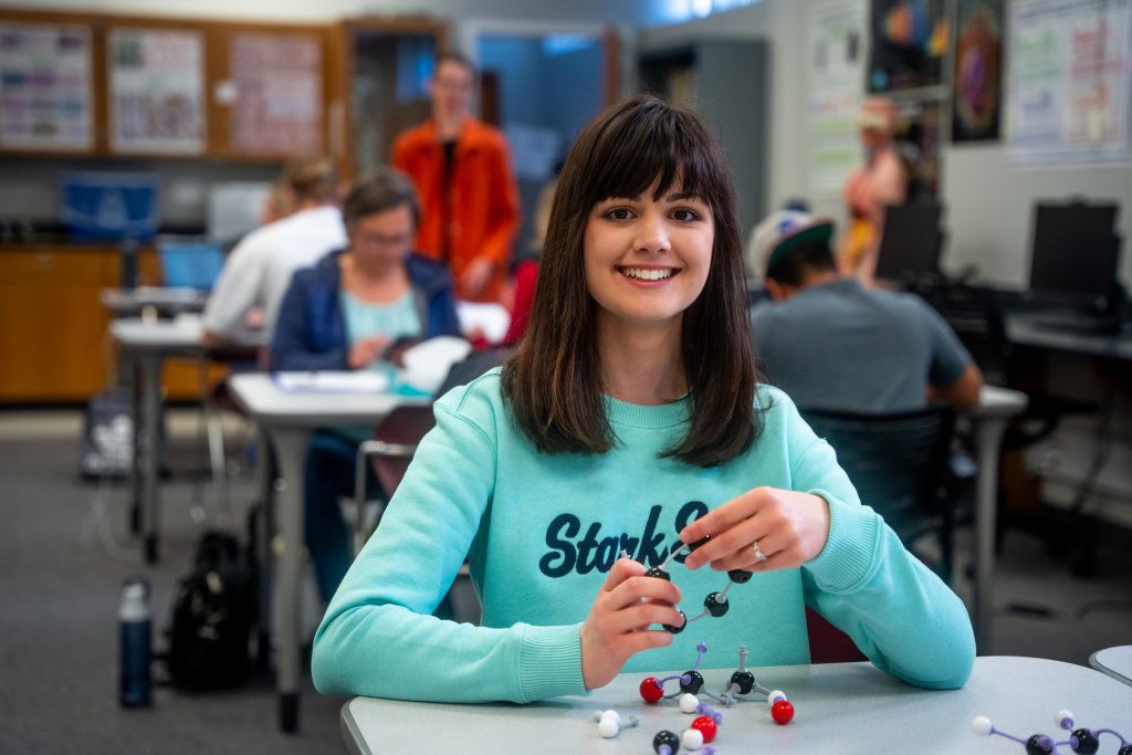 Female college student smiling at desk