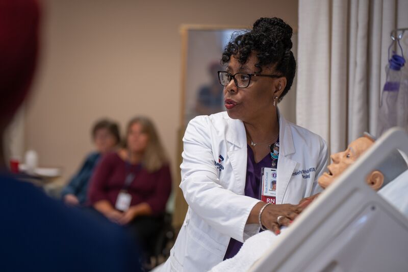 Associate degree in nursing, lab, instructor teaching how to use simulator