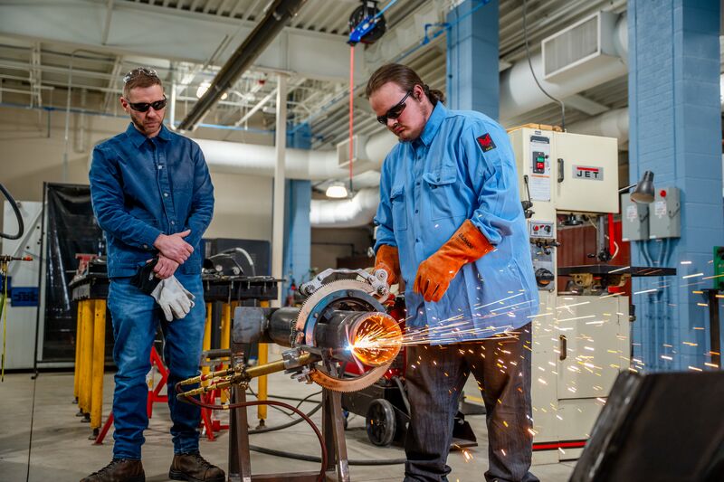 Welding student and instructor conducting welding demonstration