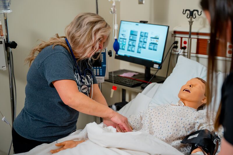 Practical Nursing, LPN, female students working on nursing simulator