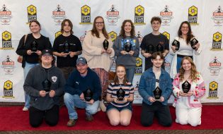 Spartan Media Award Winner, two rows of students holding their awards, smiling students