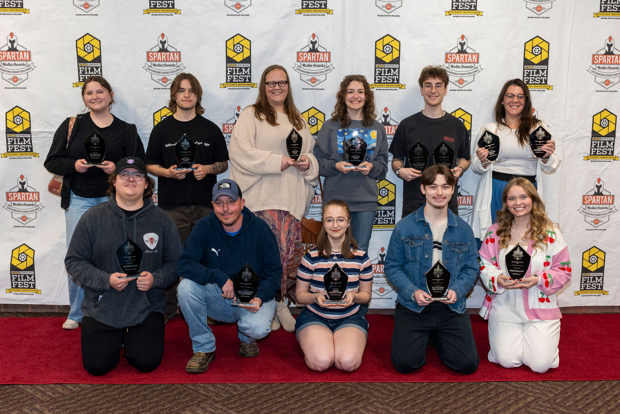 Spartan Media Award Winner, two rows of students holding their awards, smiling students