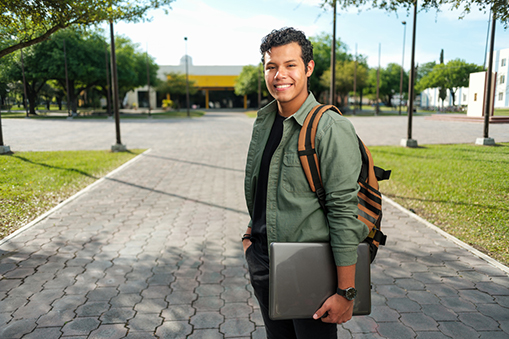 College Credit Plus CCP, A handsome male college student smiling looking at the camera holding a laptop.