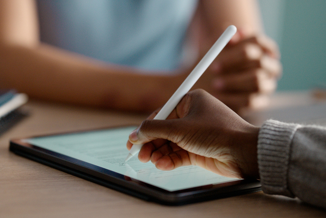 Hands, tablet and online signature for contract meeting with agreement for employment for document, form or collaboration. Businesspeople, internet and partnership in London, digital or paperwork