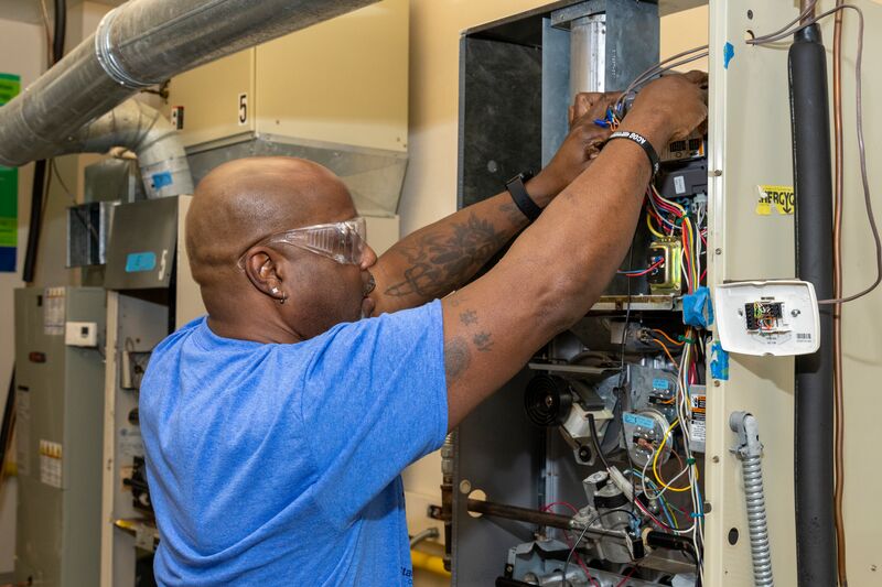 HVACR student working on wiring on an air conditioner