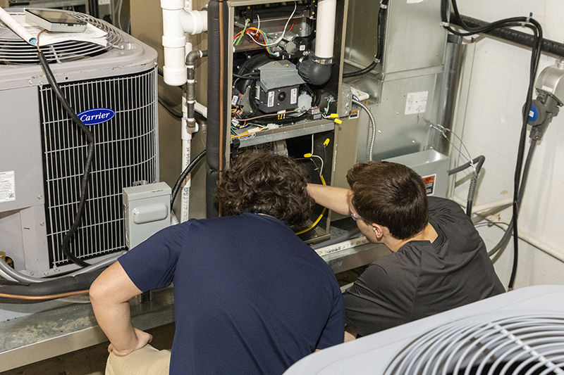 HVACR students working on an air conditioner