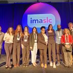 Nine IMA students and instructor pose for a group picture
