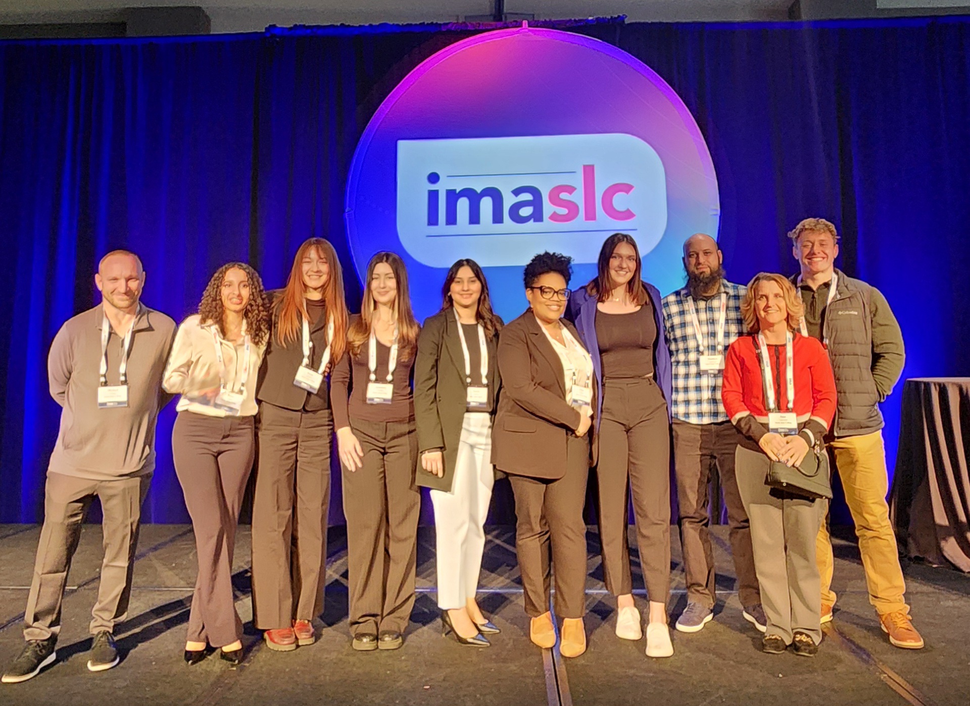 Nine IMA students and instructor pose for a group picture