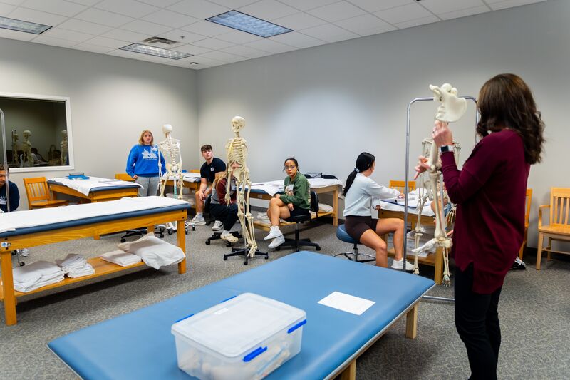 Physical therapy assisting program, instructor teaching lesson as students watch