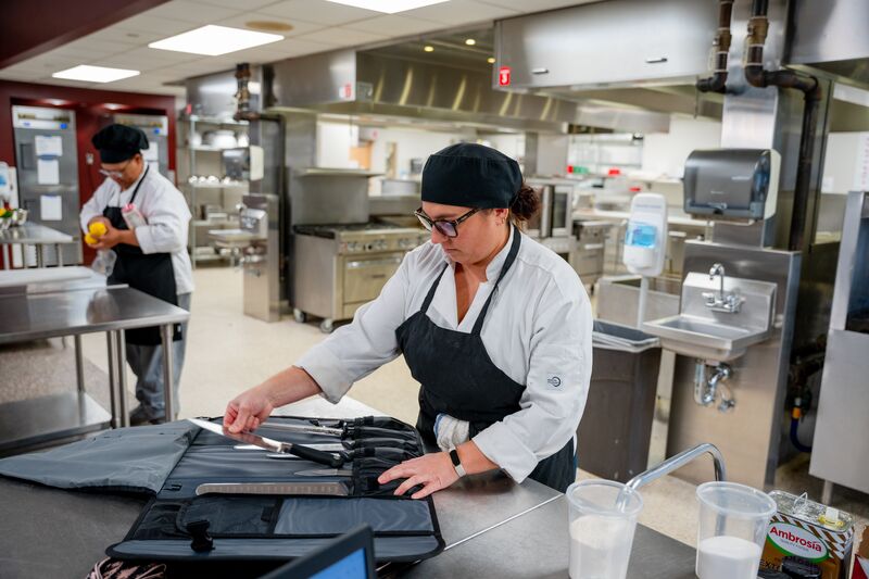female culinary student organizing knives