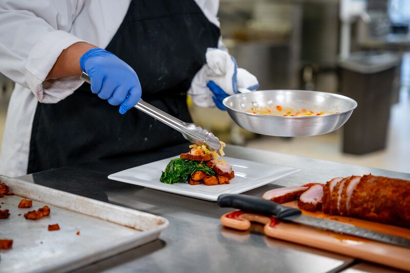 Culinary arts, hands preparing dish