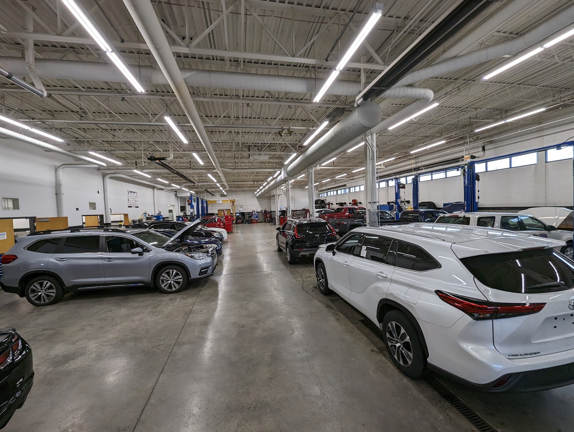 Automotive facility garage with several cars