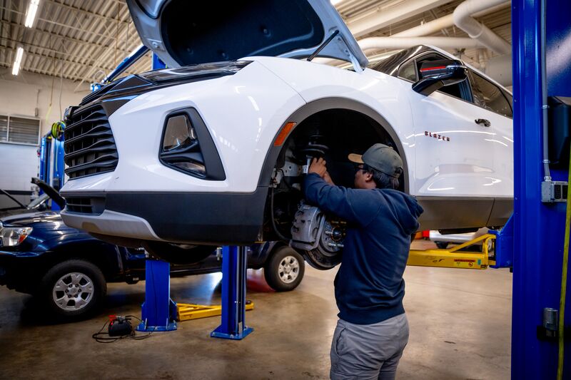 automotive student working on car brakes