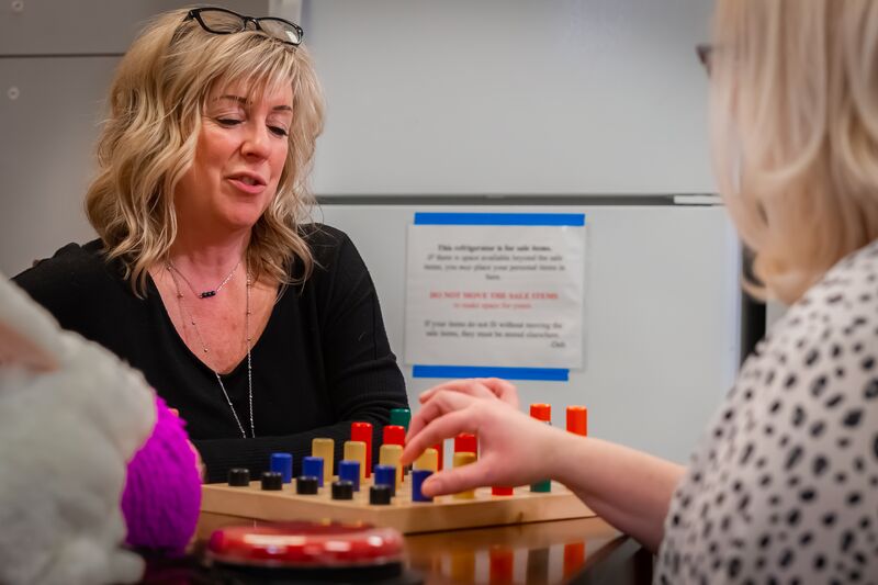 Occupational therapy, instructor working with student on hand movement