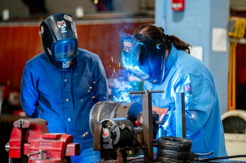 Welding student and instructor conducting welding demonstration