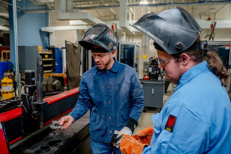 Welding student and instructor conducting welding demonstration