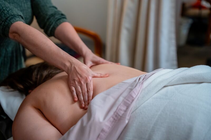 Massage therapy, female hands on back