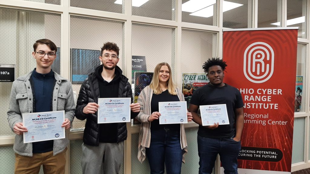 Cyber Security grads holding certificates