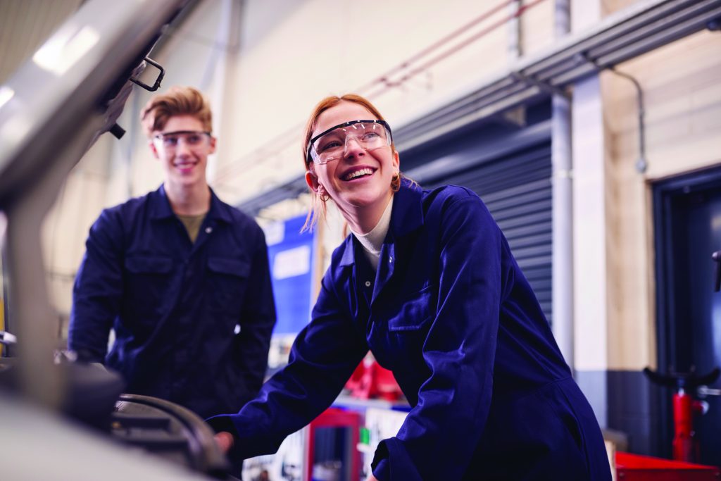 Tech prep, Male And Female Students Looking At Car Engine On Auto Mechanic Apprenticeship Course At College
