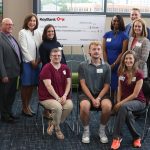 KeyBank check donation to Stark State College as members of Stark State College including three students and representatives from KeyBank pose picture in front of large check.