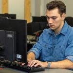 Gavin Williams, student at computer and typing on keyboard