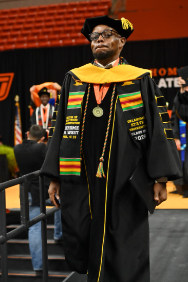 Jerome West at graduation wearing his regalia
