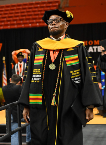 Jerome West at graduation wearing his regalia